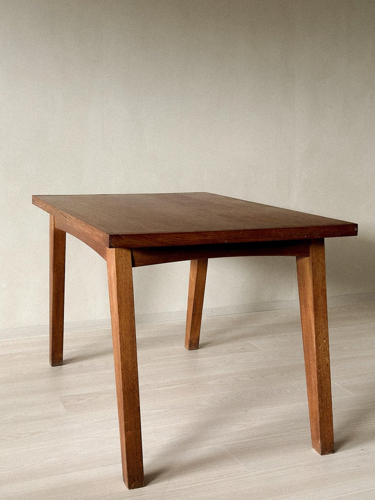 Side view of 1950s French oak table with minimalist lines