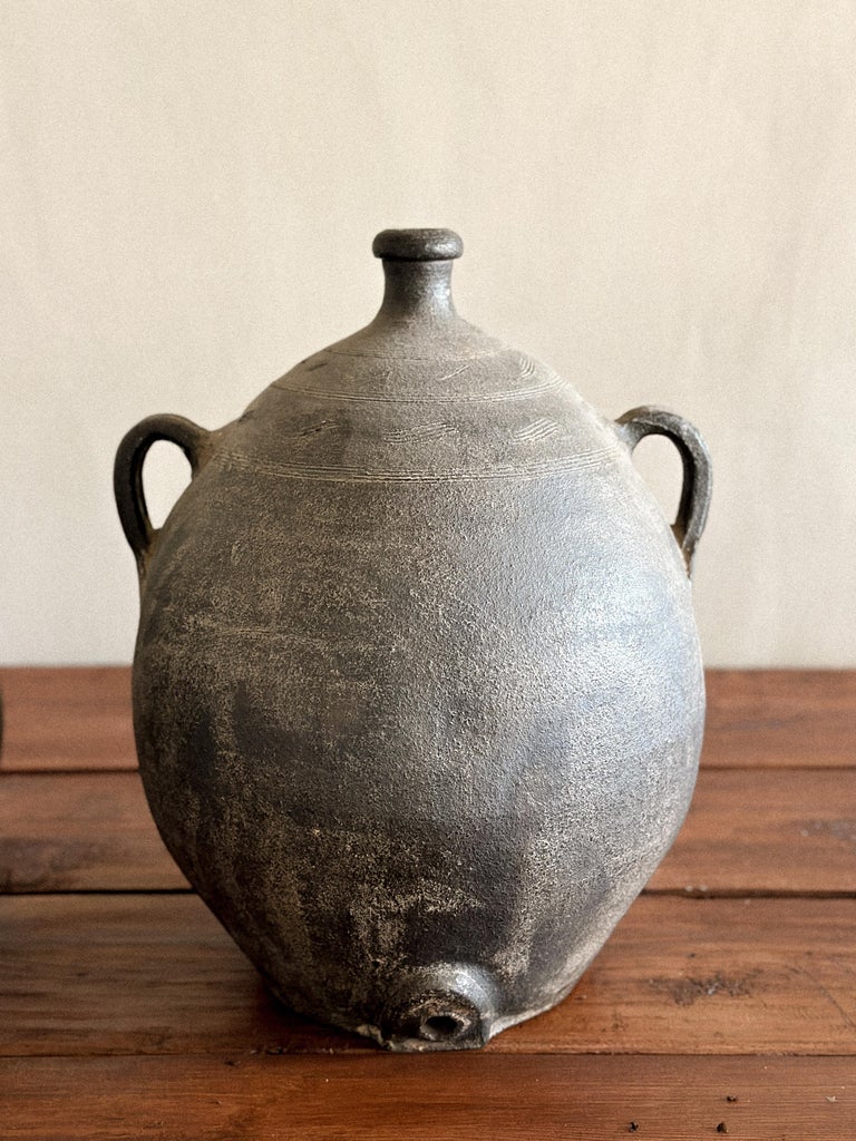Handmade Spanish ceramic pots with worn surface and side spouts