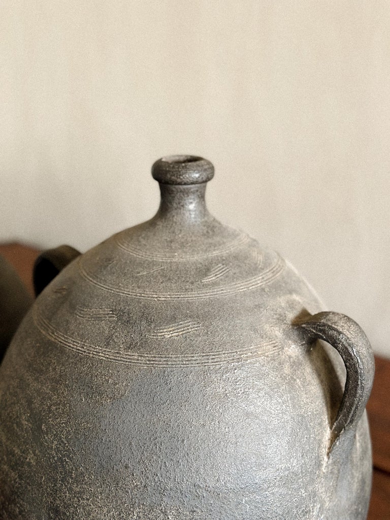19th-century amphora-style jars with visible aging and texture