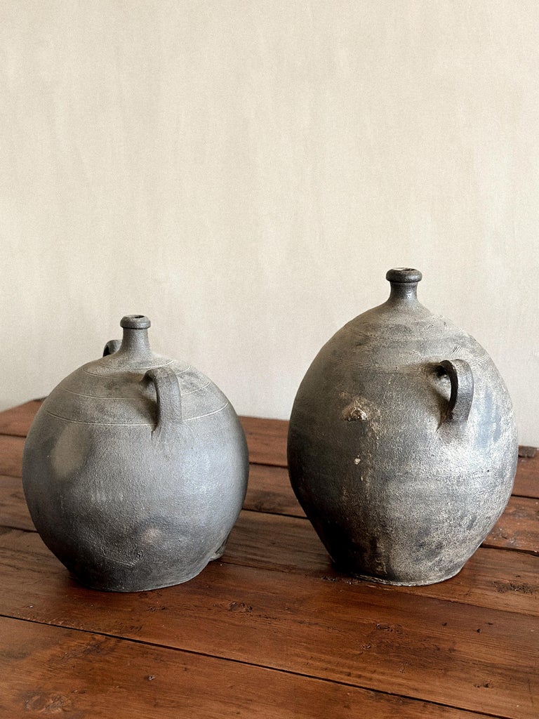 Aged Spanish clay jars with simple, timeworn form and dual handles