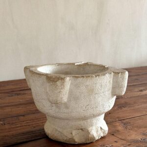 Antique limestone mortar with worn surface and rounded edges