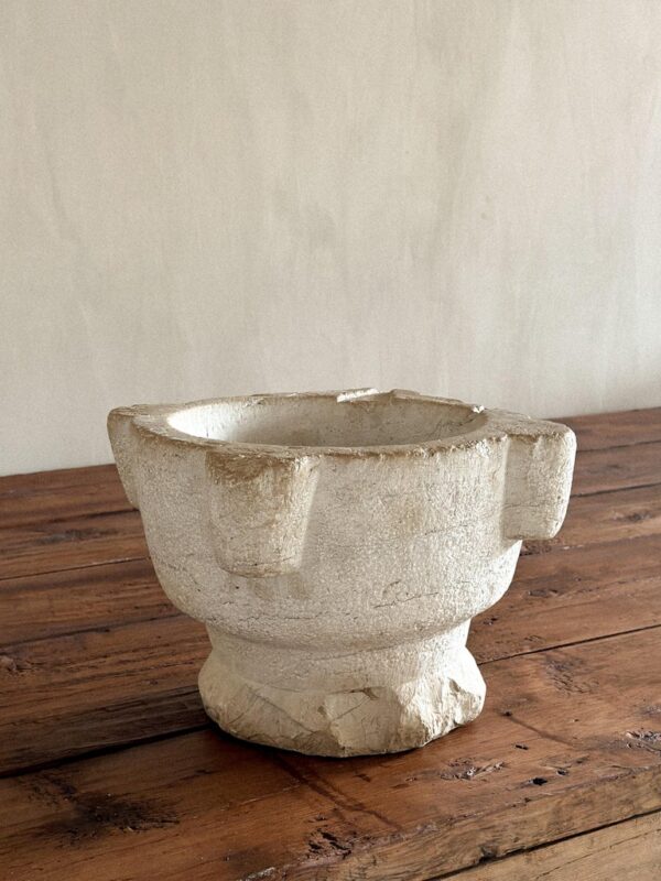 Antique limestone mortar with worn surface and rounded edges