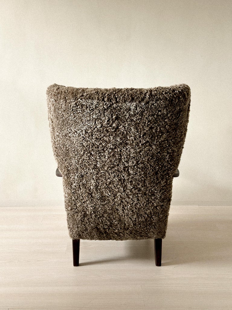 Vintage Danish lounge chair in sheepskin and dark stained wood