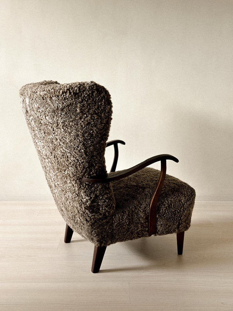 Rear view of 1940s Danish wing chair with rich wood grain