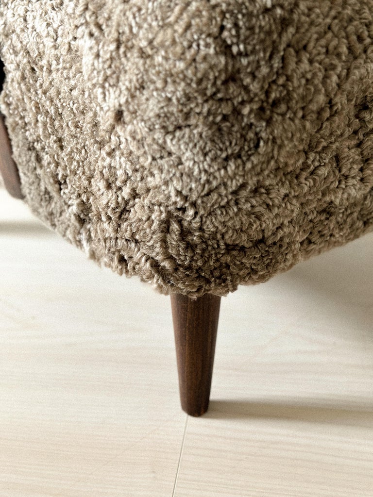 Sculpted frame and soft upholstery on cabinetmaker’s chair