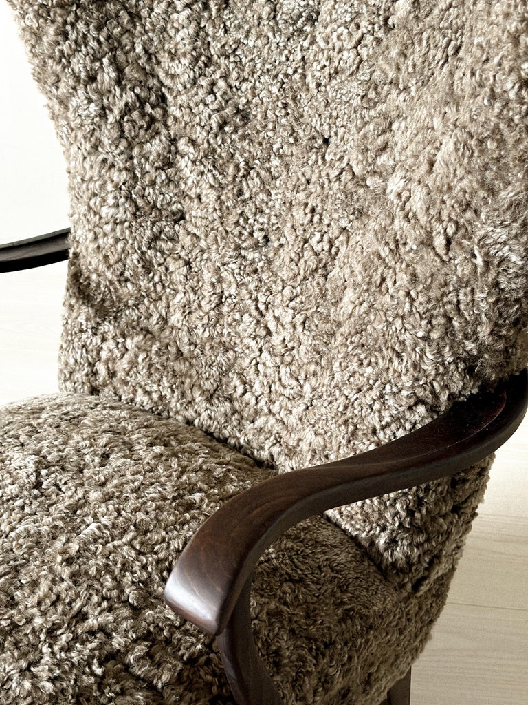Close-up of curved armrest on Danish sheepskin lounge chair