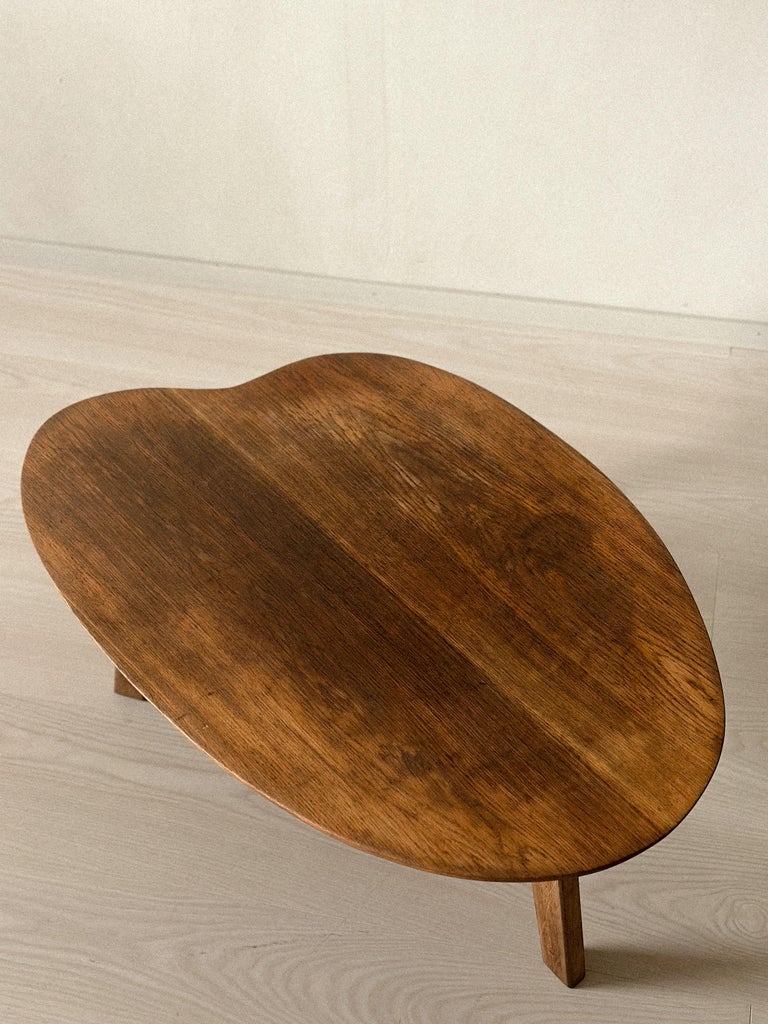 1950s low table with curved solid wood top and tapered legs