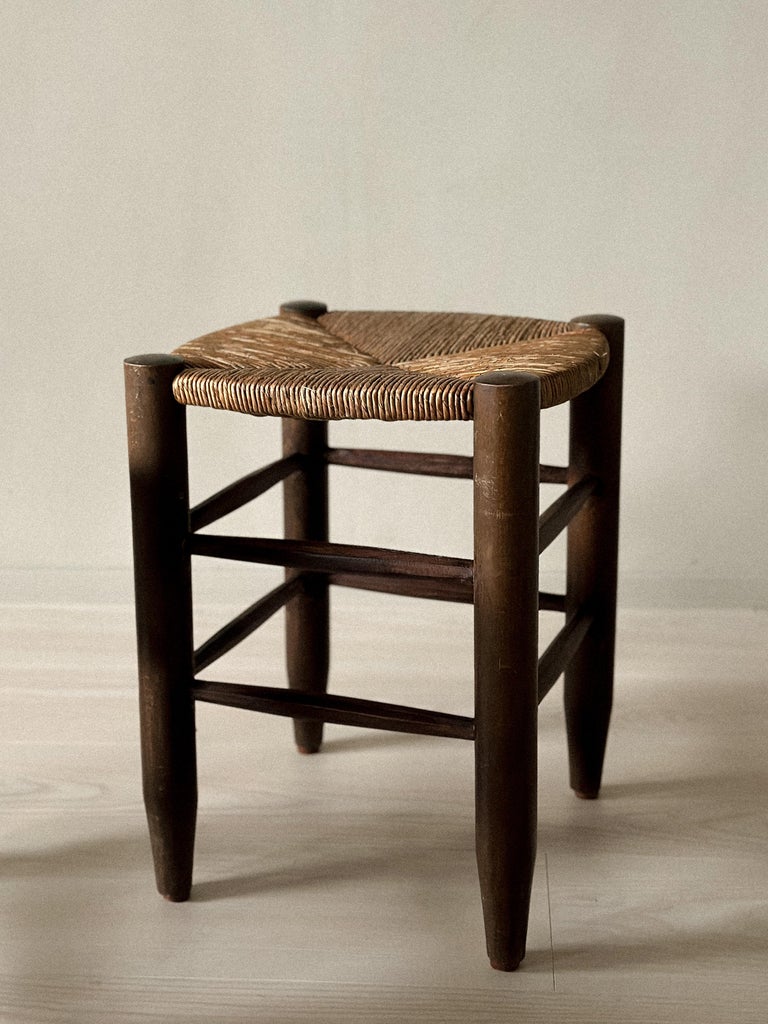 Underside of rattan stool showing wooden cross structure
