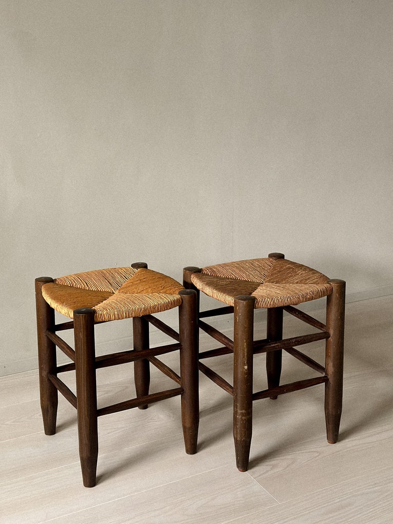 Side view of rattan and wood stool by Charlotte Perriand