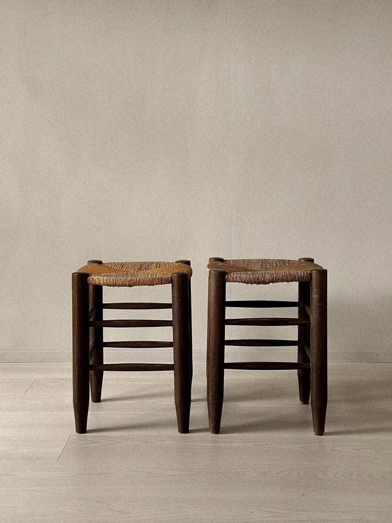 Pair of Charlotte Perriand rattan stools with circular woven seats