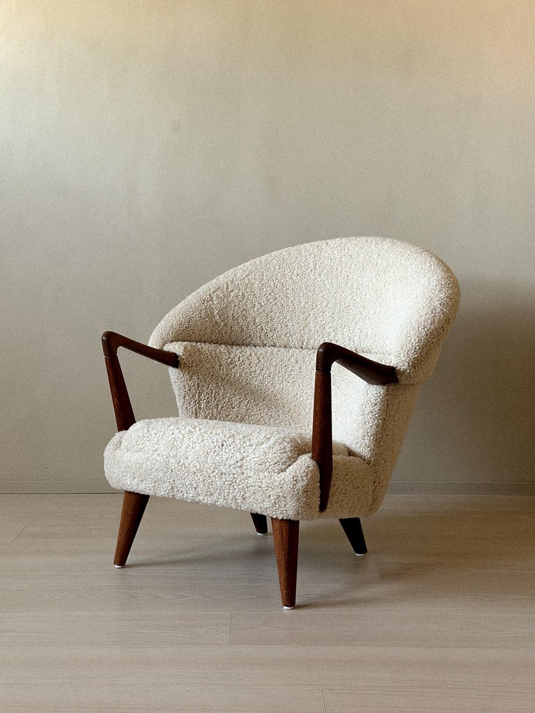 Sheepskin lounge chair with sculptural wooden arms