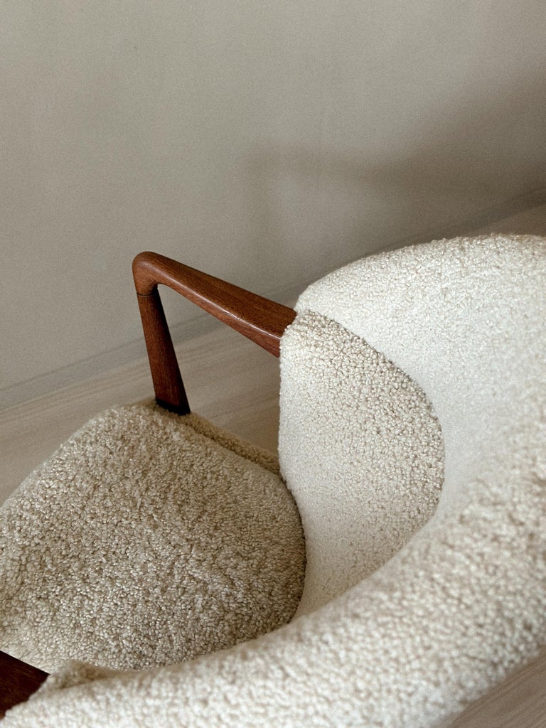 Vintage Norwegian chair with plush sheepskin and wood base