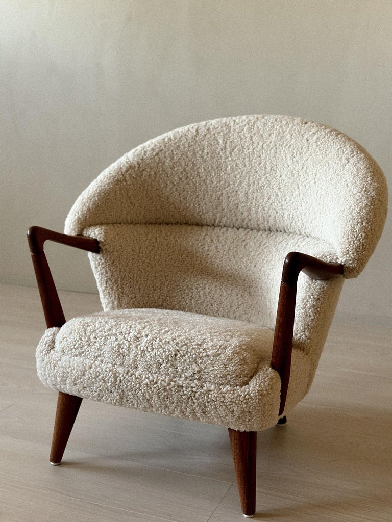 Vintage armchair with sculpted armrests and plush upholstery