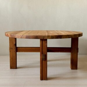 Side profile of round pine side table on neutral background