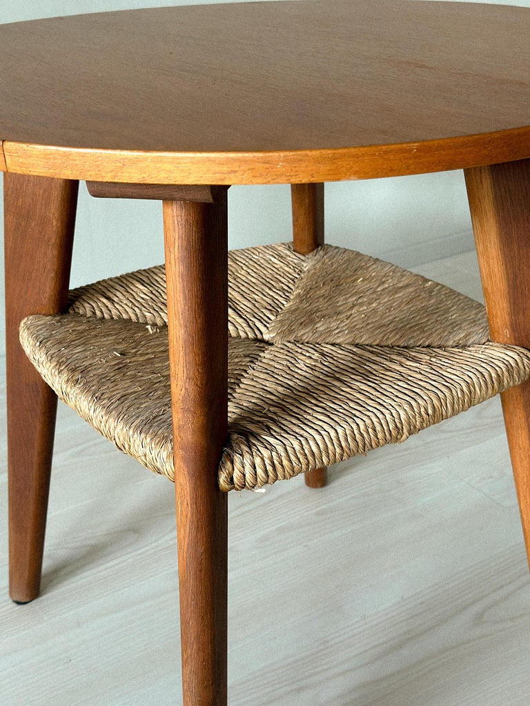 Rush-woven shelf detail on Danish mid-century side table
