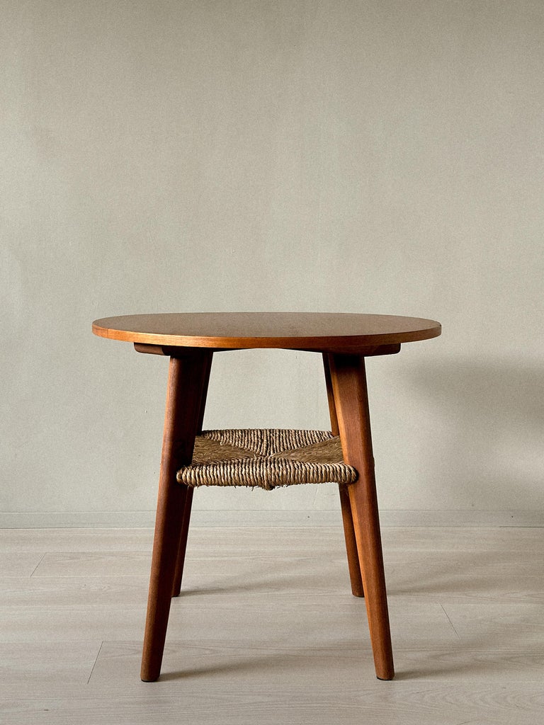 Vintage Danish side table with rush shelf and tapered legs