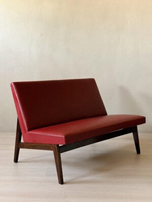 Side view of Pierre Jeanneret–style red skai bench