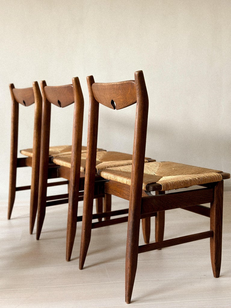 Chair seat and leg detail showing rush texture and oak frame