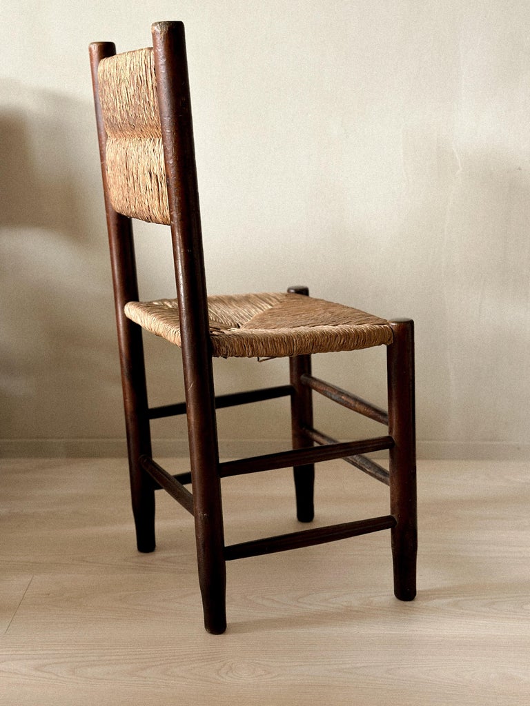 Side view of mid-century French dining chair with rush seat