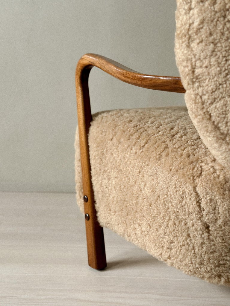 Close-up of shearling upholstery and wood leg detail