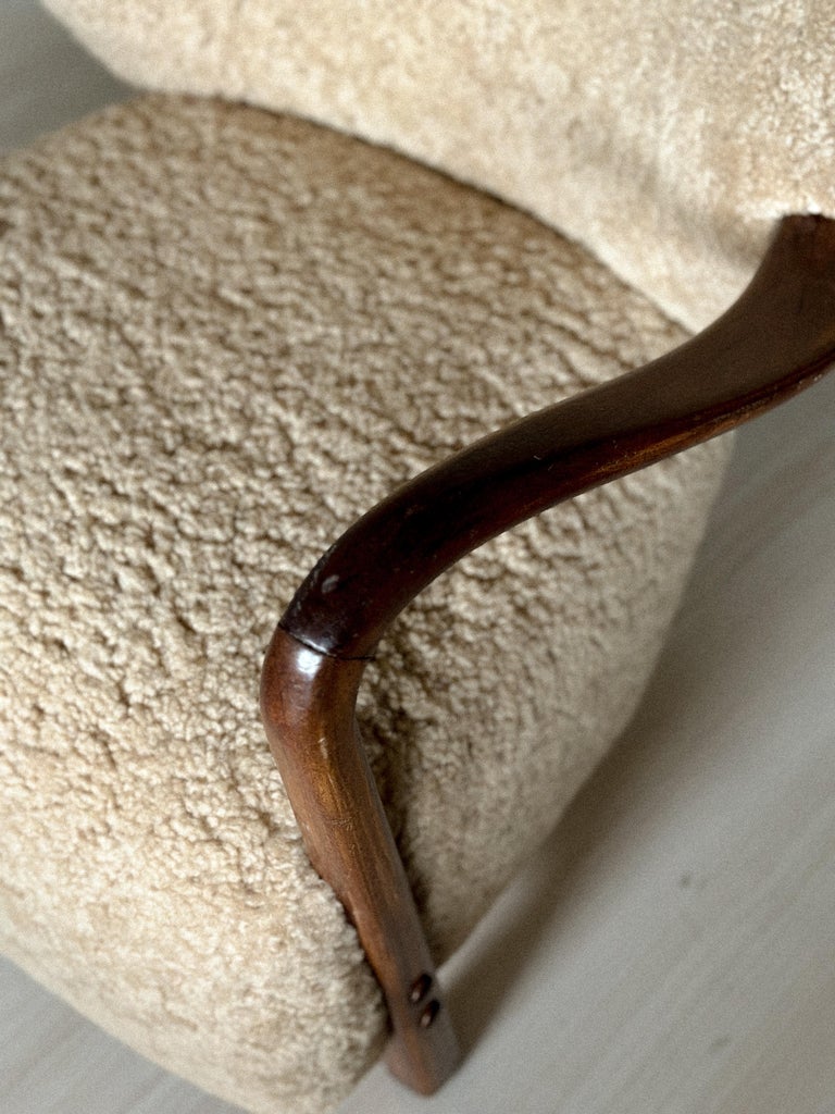 Top-down view of rounded armrests and deep seat in shearling