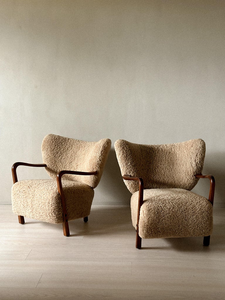 Rounded backrest and generous seat of Danish armchair
