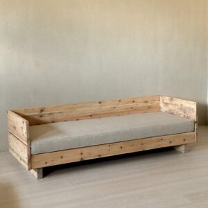 Vintage wooden daybed with new cushion in modern interior