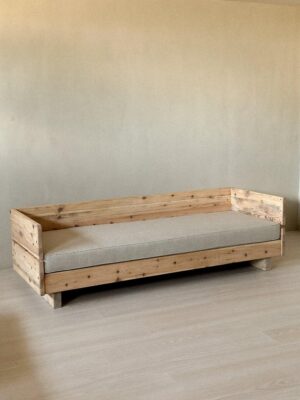 Vintage wooden daybed with new cushion in modern interior