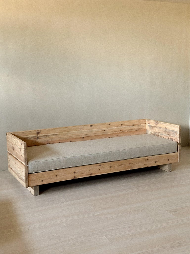 Vintage wooden daybed with new cushion in modern interior