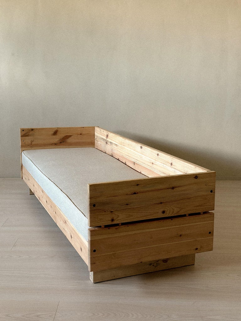 Solid wood daybed with minimalist lines and warm patina