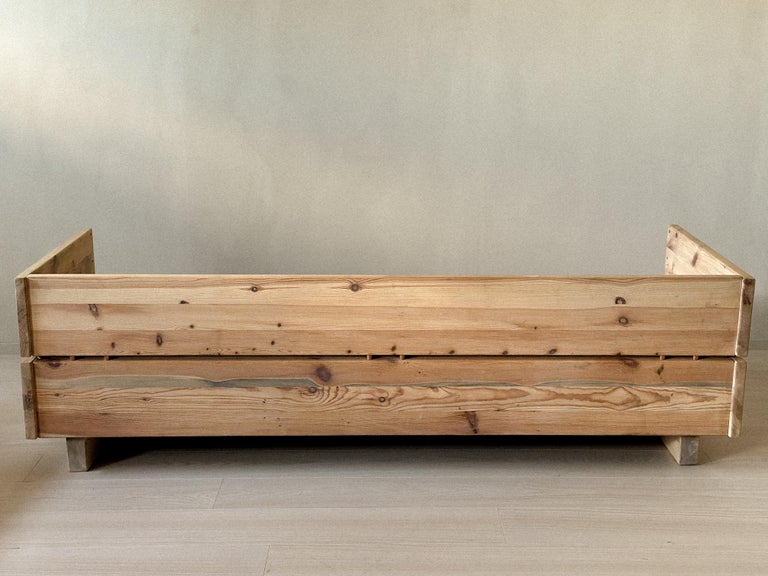 Vintage daybed styled against plaster wall