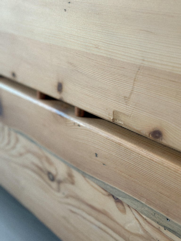 Corner wear and scratches on pine daybed