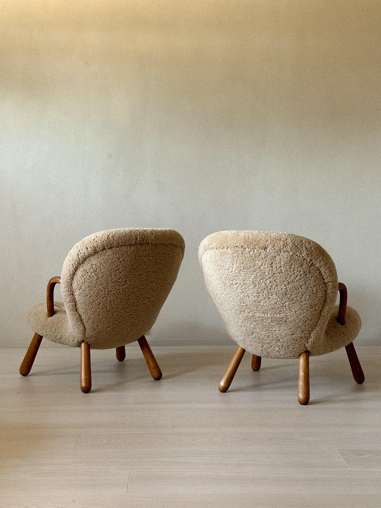 Vintage Clam Chairs arranged as a pair in bright interior