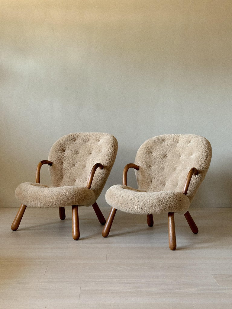 Low-slung vintage lounge chairs with curved wooden frames