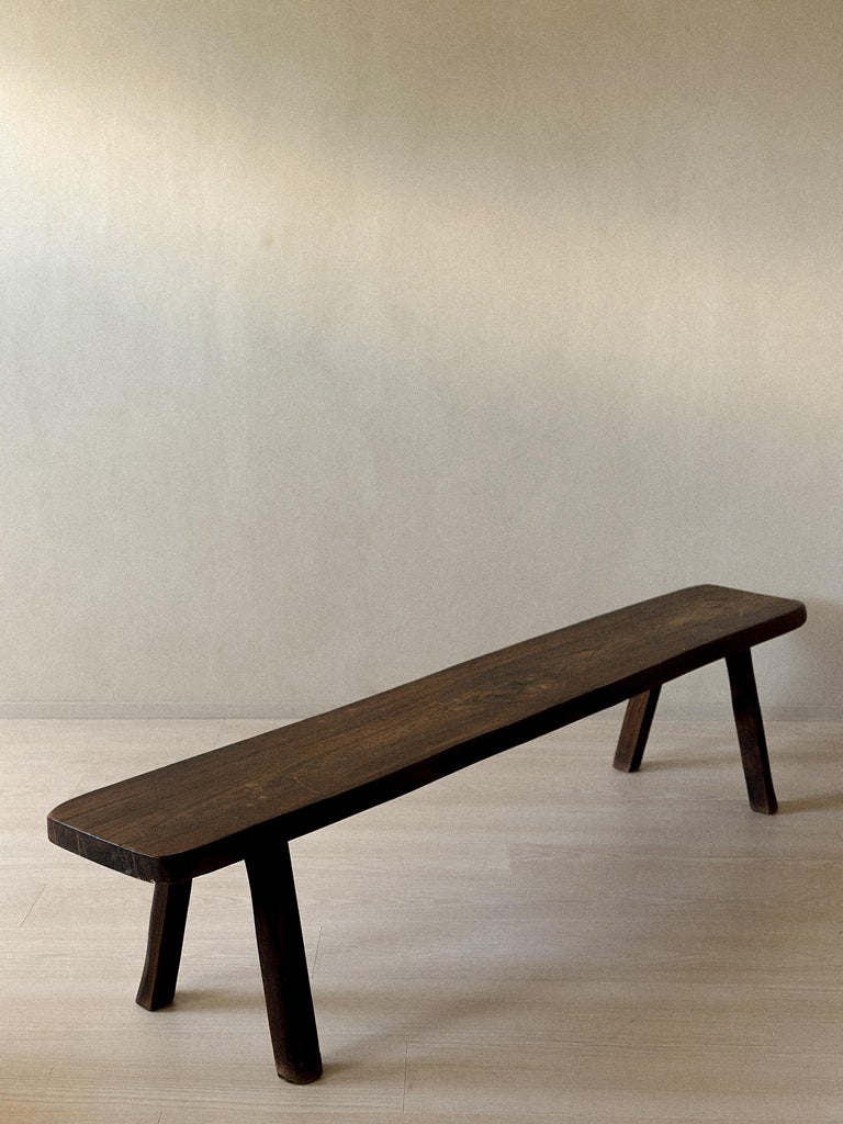 Low oak bench with rustic brutalist style