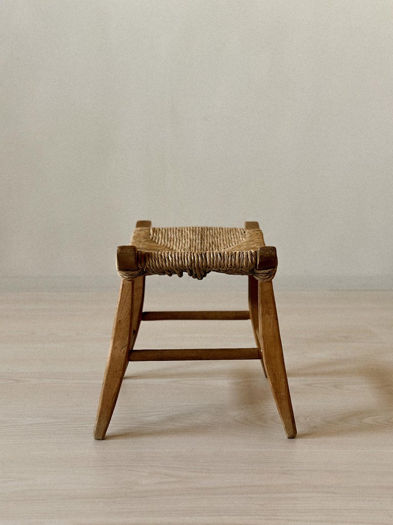 Vintage woven stool in light wood with low profile