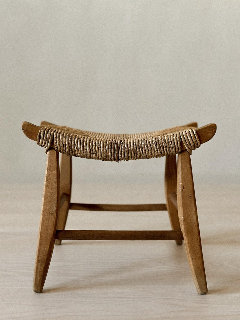 Side view of small woven wooden stool