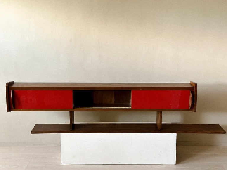 Front view of mid-century shelf with sliding doors and compartments