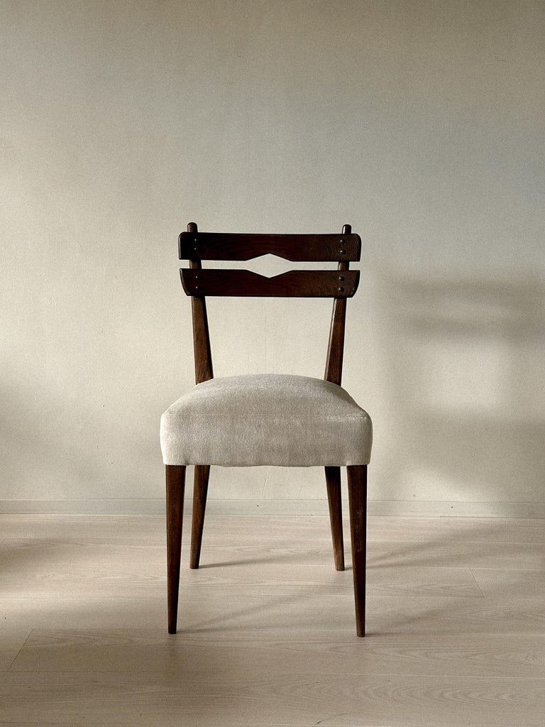Dark wooden dining chair with light upholstered seat