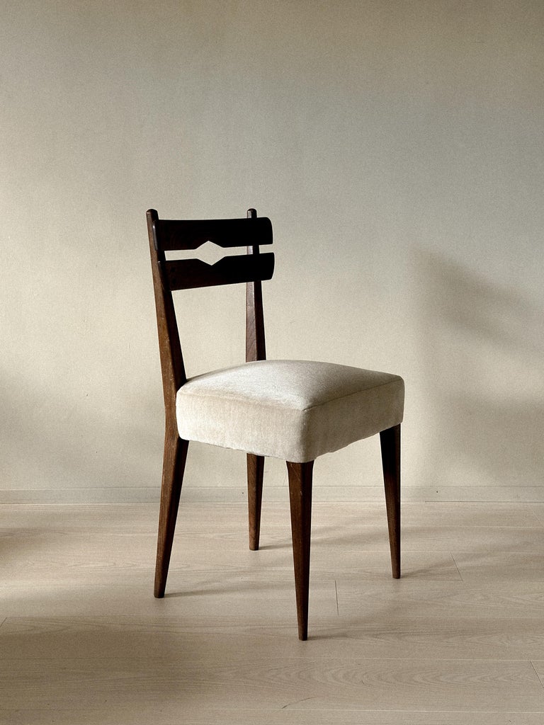 Neutral-toned seat on dark mid-century dining chair