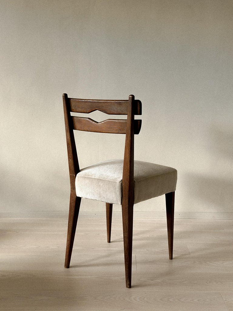 Back view of mid-century dining chairs in dark stained wood