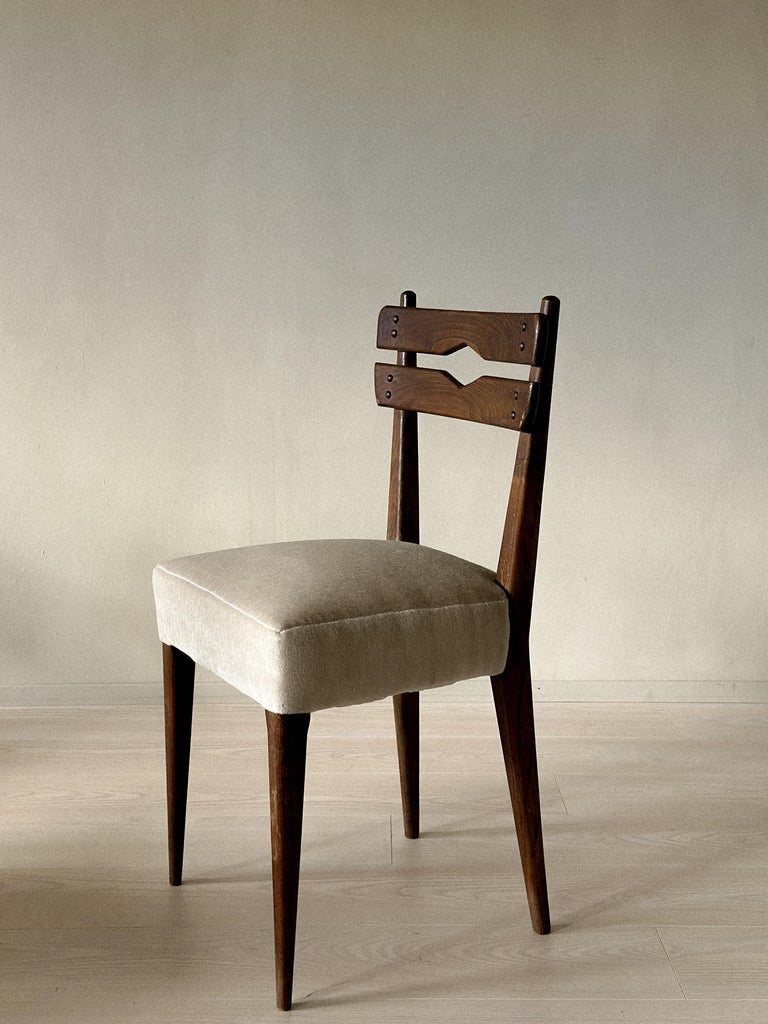 Side profile of vintage wooden dining chair with upholstered seat