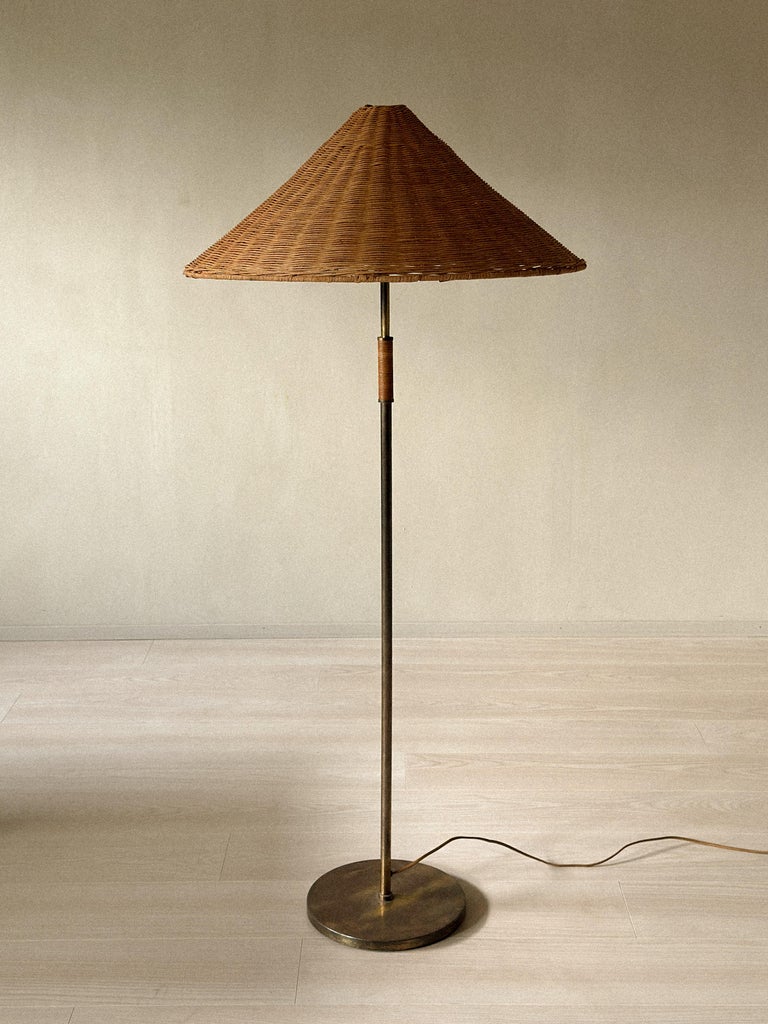 A Mid-Century Floor Lamp in Style of Paavo Tynell, Brass and Rattan, c. 1950s